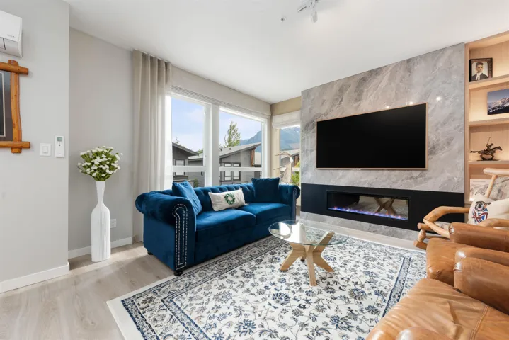 Living area with wood finished floors and a high end fireplace