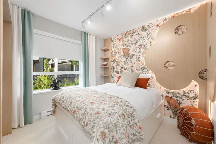 Bedroom with wallpapered walls, rail lighting, carpet flooring, and baseboard heating