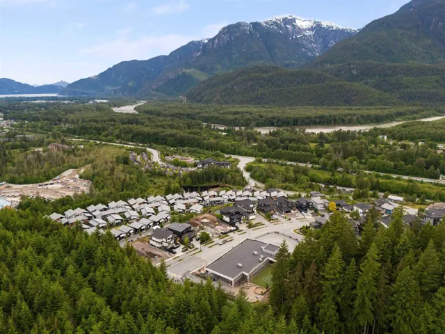 Aerial overview of property's location with a mountainous background and nearby suburban area
