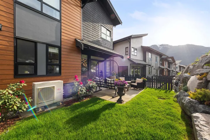 Rear view of house with a mountain view and a patio area