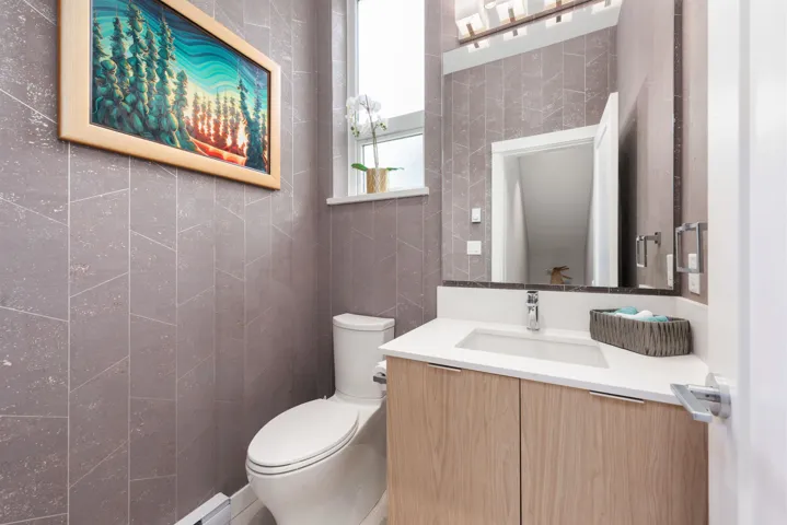 Bathroom featuring tile walls and vanity