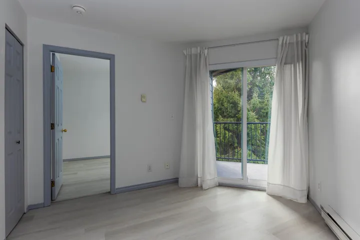 Spare room featuring baseboard heating and light wood-style flooring