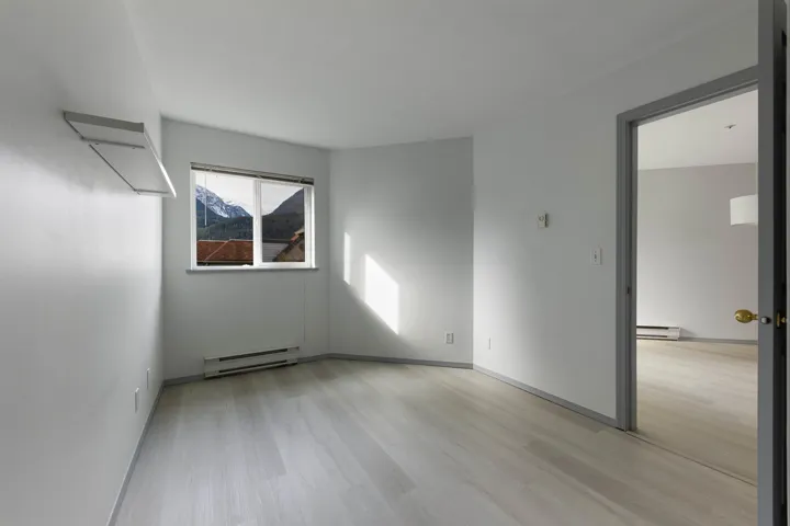 Spare room with baseboard heating and light wood finished floors