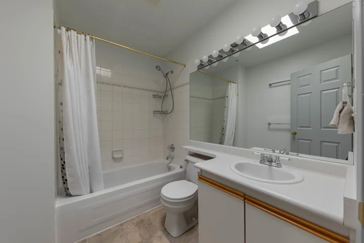 Full bathroom featuring vanity and shower / bathtub combination with curtain