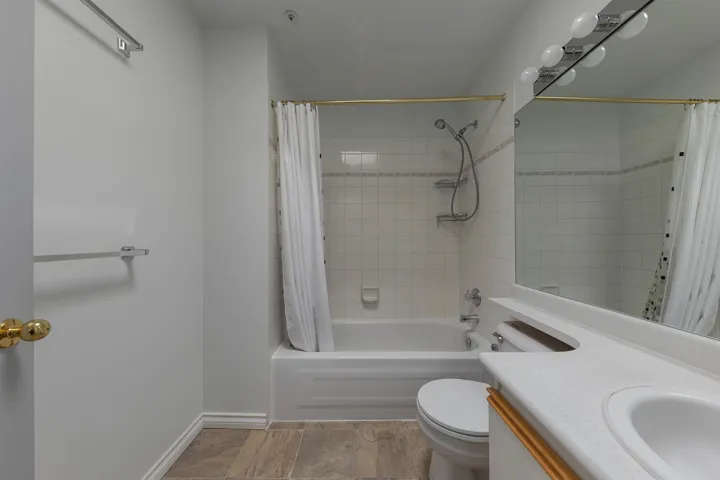 Bathroom with vanity and shower / bath combination with curtain