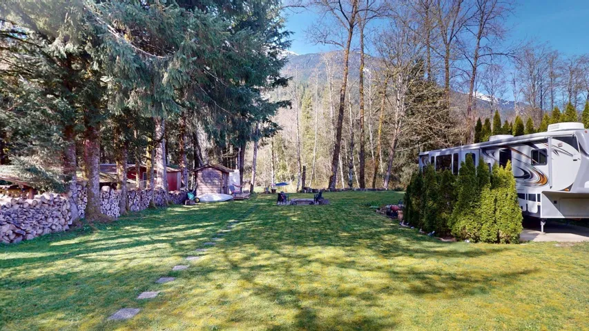 View of green lawn featuring a mountain view