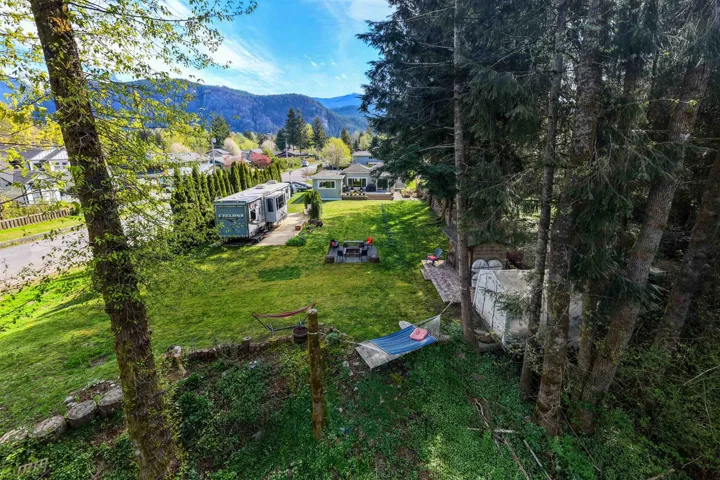 Expansive grassy yard area with partial mountain backdrop