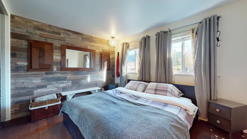 Accent wall featuring wood-finish paneling and dark wood-frame mirrors
