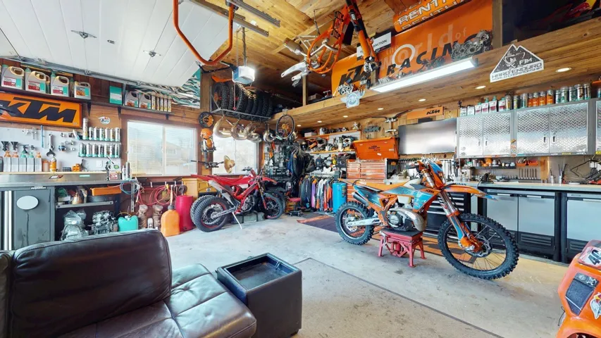 Garage with a workshop area and a garage door opener