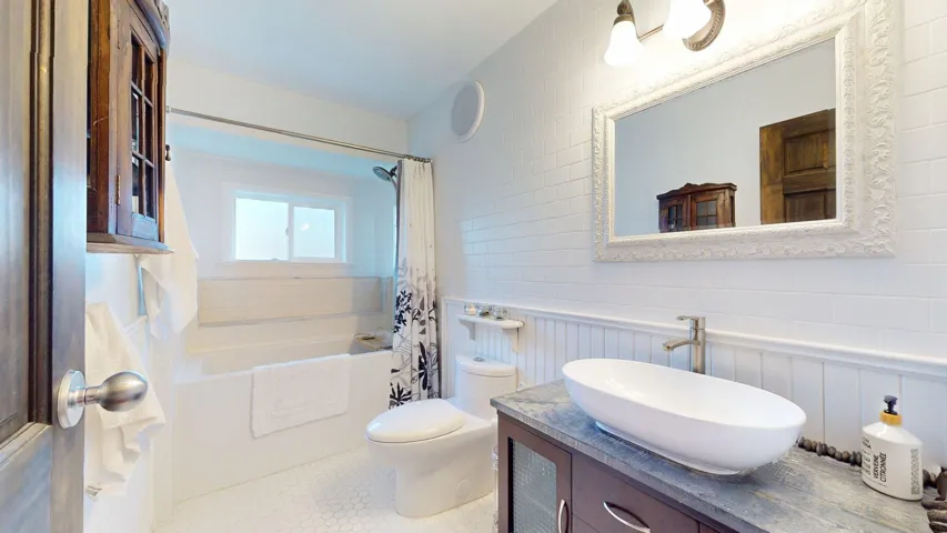 Full bath featuring vanity and shower / tub combo and heated floor.