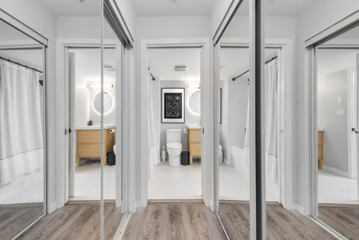 Interior space with toilet, visible vents, wood finished floors, and vanity
