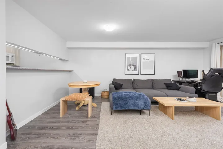 Living area featuring baseboards and wood finished floors