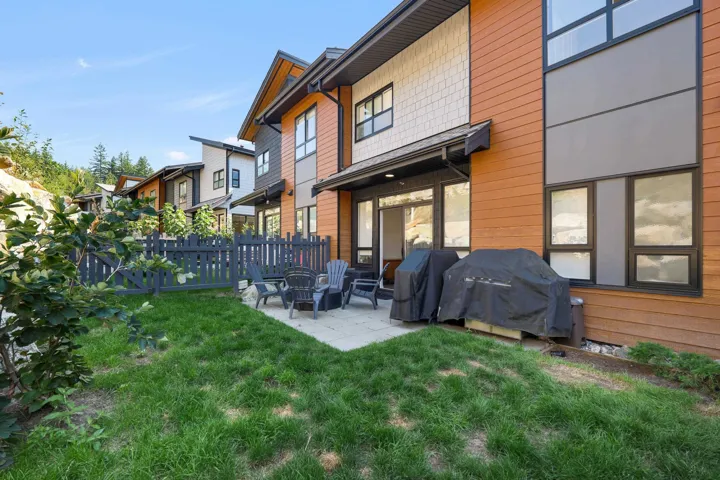 Back of house with a patio area and an outdoor fire pit