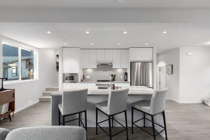 Kitchen featuring a center island with sink, stainless steel appliances, a breakfast bar area, light wood-type flooring, and recessed lighting