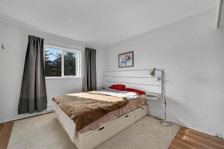 Bedroom with light wood-type flooring and baseboards