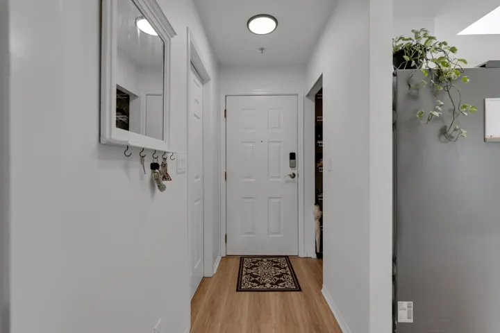 Doorway with light wood finished floors