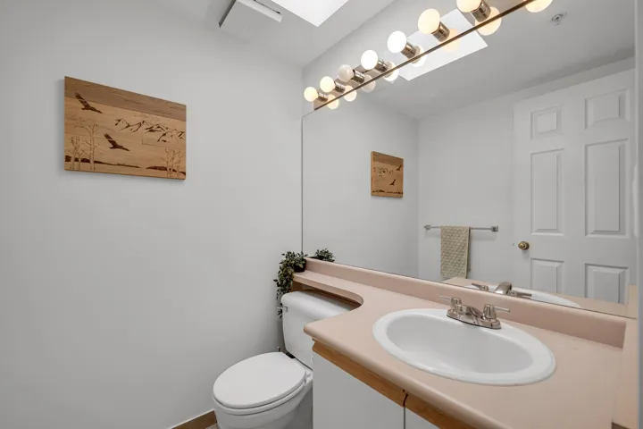 Half bathroom with vanity and toilet