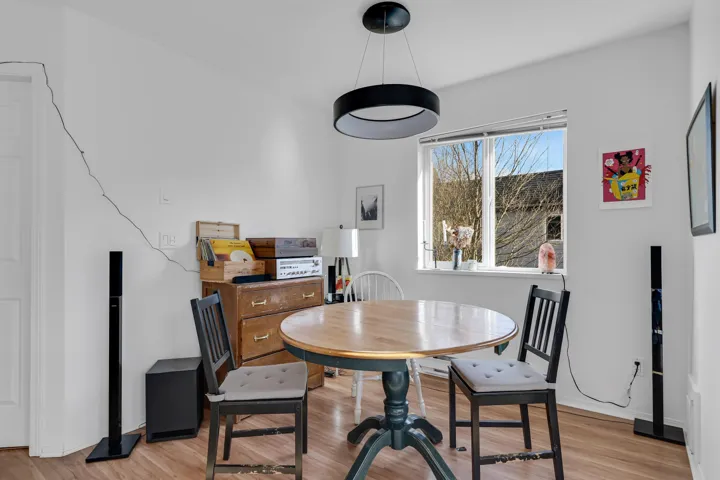 Dining space with light wood-style flooring and baseboards