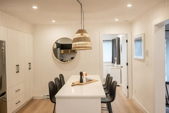 Dining room featuring recessed lighting, a baseboard radiator, baseboards, and light wood-style flooring