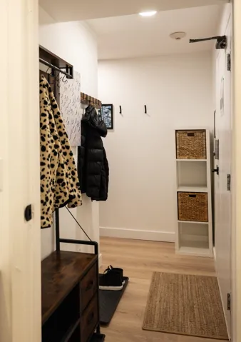 Mudroom featuring light wood-style flooring and baseboards