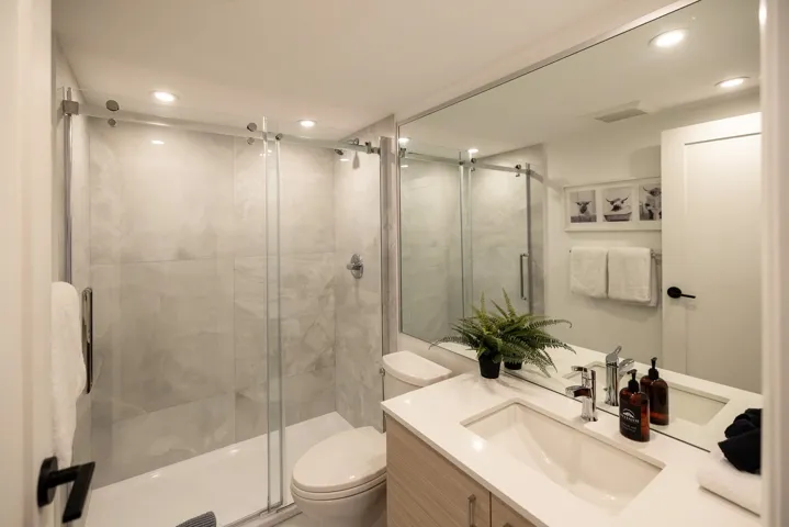 Bathroom with visible vents, toilet, a stall shower, recessed lighting, and vanity