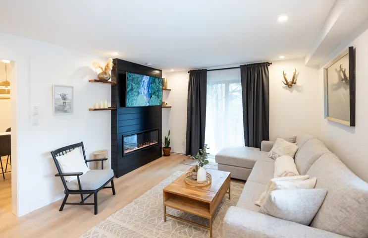 Living room with recessed lighting, baseboards, light wood-style floors, and a fireplace
