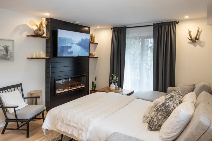 Bedroom featuring recessed lighting, a large fireplace, and wood finished floors