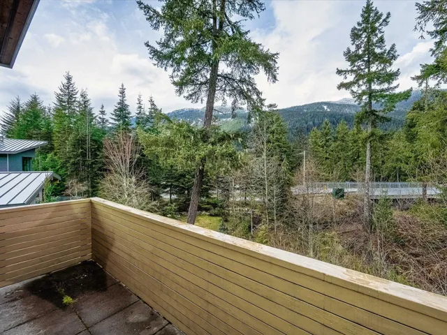 Balcony with a wooded view and a mountain view