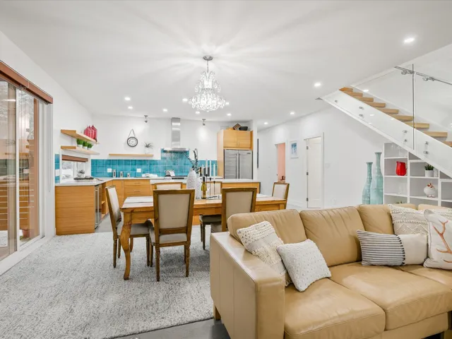 Living area featuring stairs, recessed lighting, a chandelier, and wine cooler