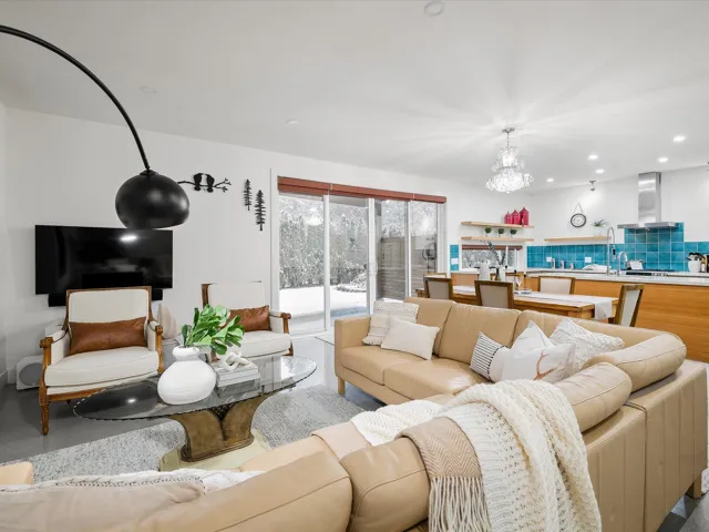 Living area with recessed lighting and a notable chandelier
