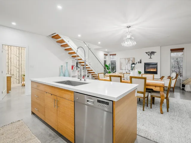 Kitchen with finished concrete flooring, an island with sink, recessed lighting, a sink, and dishwasher