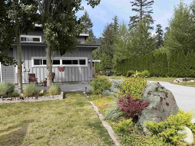 Modern gray vertical siding exterior with white window frames
