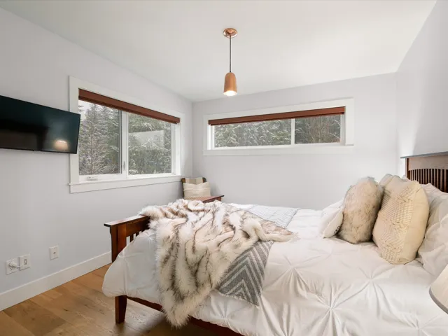 Bedroom with baseboards and wood finished floors