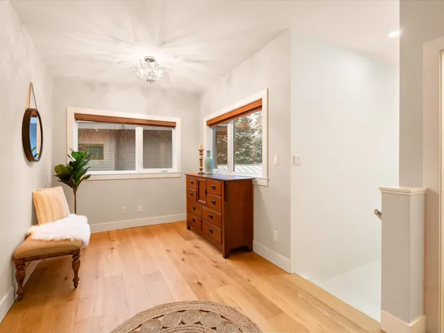 Living area with an inviting chandelier, baseboards, and light wood-style floors