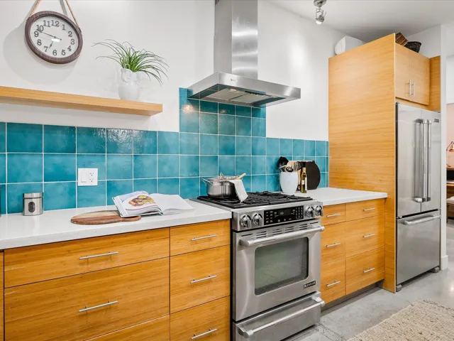 Kitchen featuring light countertops, wall chimney exhaust hood, and stainless steel appliances