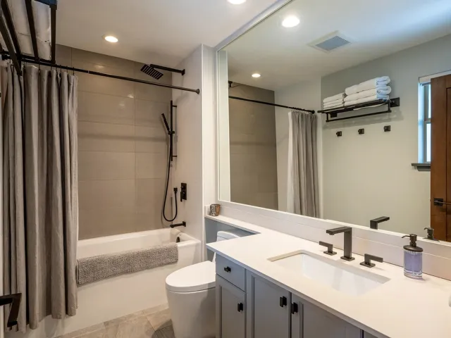 Full bath with shower / bath combo, visible vents, toilet, recessed lighting, and vanity
