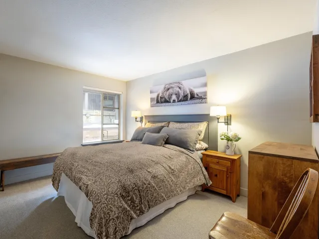 Bedroom with light colored carpet