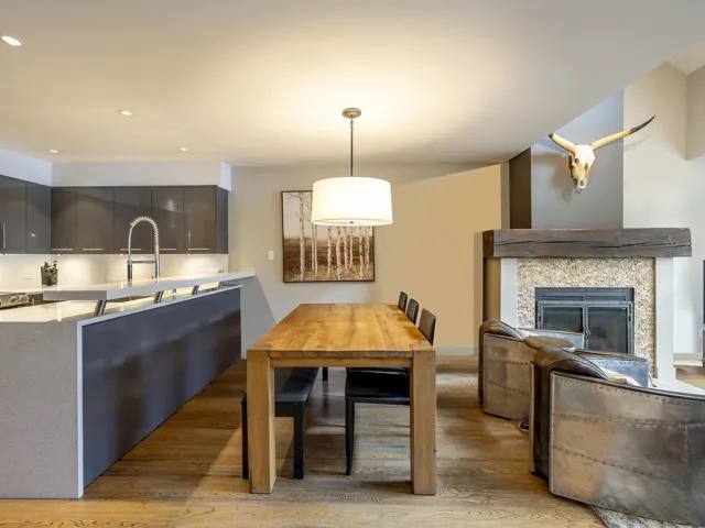 Dining area featuring recessed lighting, light wood-style flooring, and a glass covered fireplace