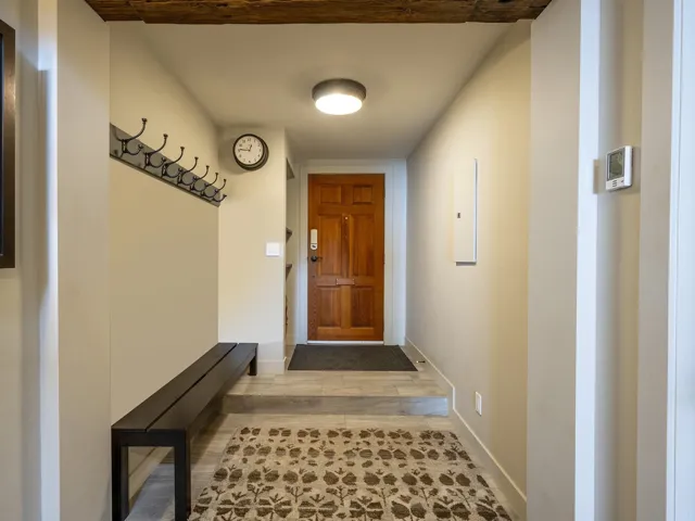 Doorway with baseboards and wood finished floors