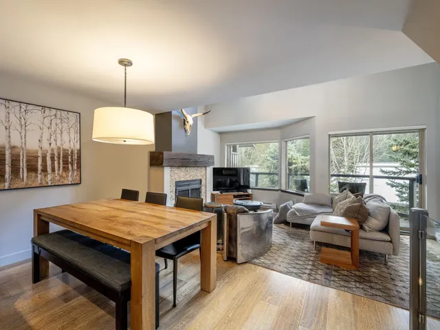 Dining room featuring baseboards, a fireplace, and light wood-type flooring