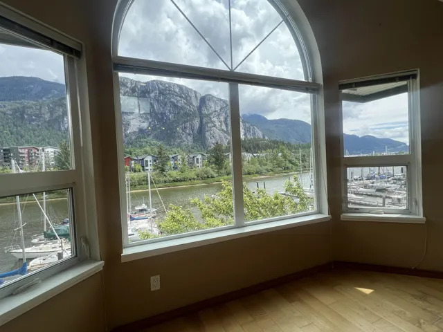 Unfurnished sunroom with a water and mountain view