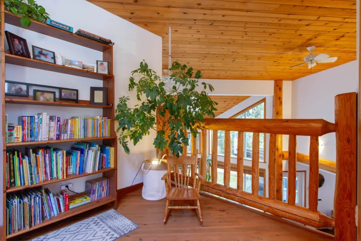 Living area featuring lofted ceiling, wood ceiling, ceiling fan, and hardwood / wood-style floors