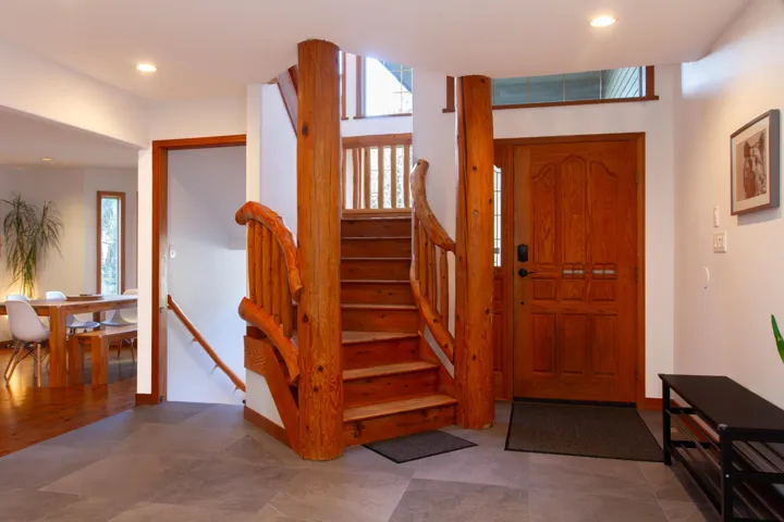 Foyer entrance with recessed lighting, baseboards, and stairs