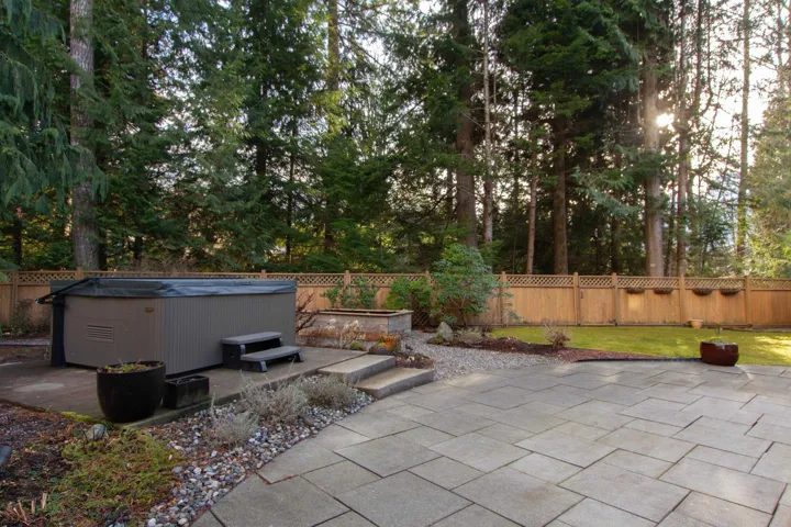 View of patio featuring a hot tub and a fenced backyard