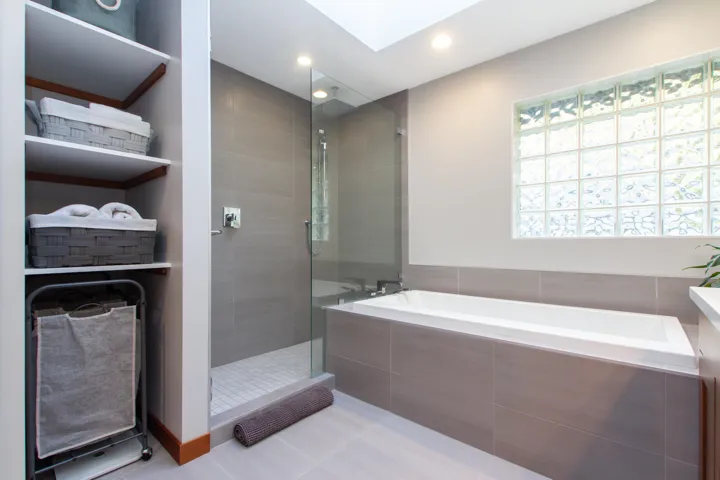 Full bathroom with a skylight, a garden tub, recessed lighting, a shower stall, and tile patterned floors