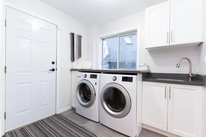 Washroom featuring cabinet space, a sink, and separate washer and dryer