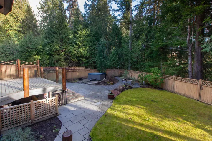 View of yard with a hot tub, a patio, a fenced backyard, and a wooden deck