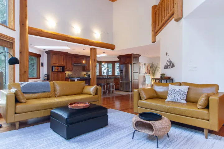 Living room with light wood finished floors and a towering ceiling