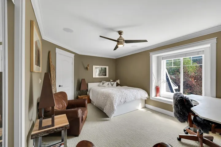Recessed lighting and a modern ceiling fan complement the room's neutral wall tones
