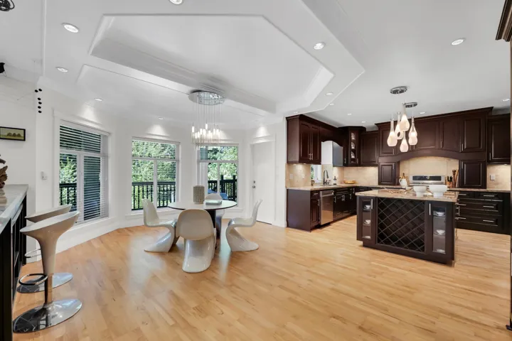 Spacious kitchen featuring rich wood cabinetry, granite countertops, and stainless steel appliances